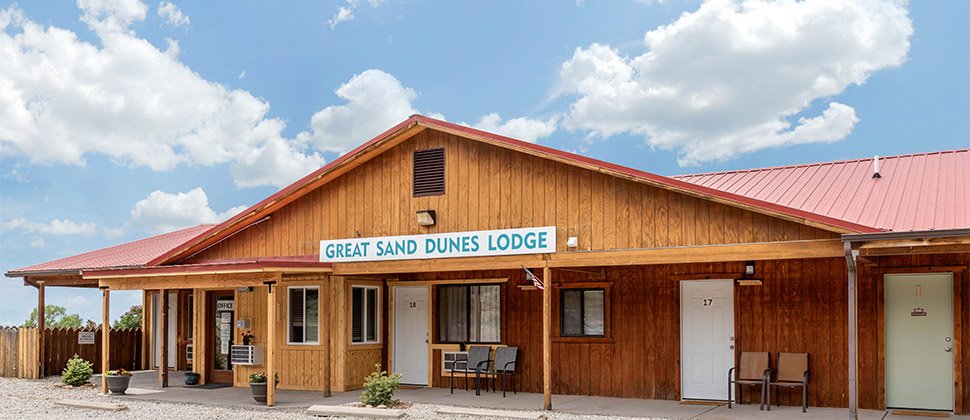 The Great Sand Dunes Lodge sign hung above the entrance to the office. 